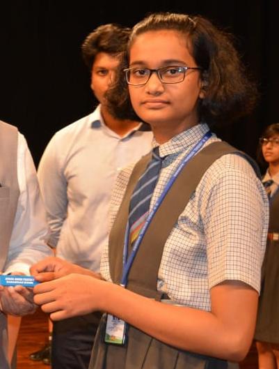 Akshara in school uniform at an event